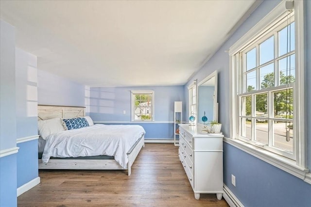127 Main St, Norwell, MA 02061 - bedroom with wood finished floors, baseboards, and a baseboard heating unit