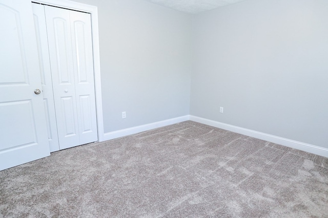 unfurnished bedroom featuring a closet and carpet flooring