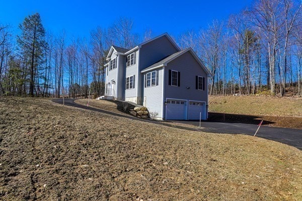 view of side of home featuring a garage