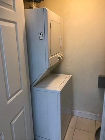 1 Millbrook Ln Unit 201, Wakefield, MA 01880 - laundry room featuring stacked washing machine and dryer and light tile patterned floors