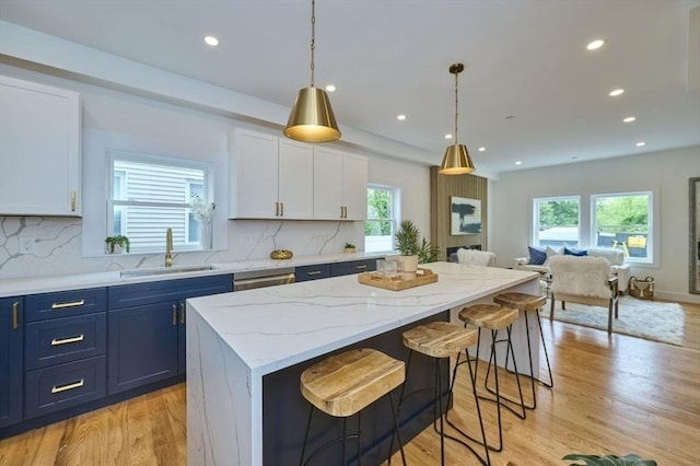 18 Belknap St Unit 2, Arlington, MA 02474 - kitchen with open floor plan, plenty of natural light, white cabinetry, a kitchen island, and recessed lighting