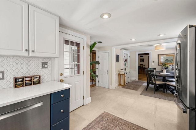 271 Haverhill St, North Reading, MA 01864 - kitchen featuring freestanding refrigerator, blue cabinetry, white cabinetry, light countertops, and decorative backsplash