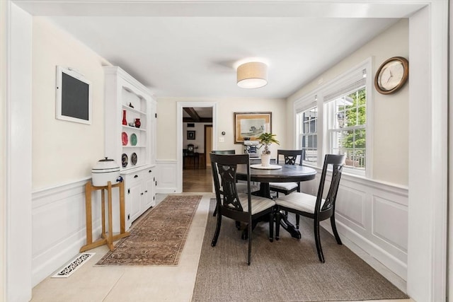271 Haverhill St, North Reading, MA 01864 - dining space with a decorative wall, wainscoting, and built in shelves