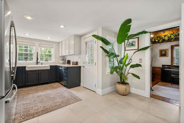271 Haverhill St, North Reading, MA 01864 - kitchen featuring freestanding refrigerator, a sink, light countertops, baseboards, and light tile patterned floors
