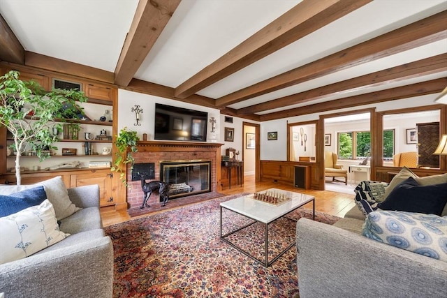 271 Haverhill St, North Reading, MA 01864 - living room featuring light wood-style flooring, a fireplace, and beamed ceiling