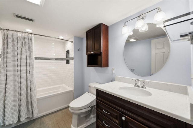 271 Haverhill St, North Reading, MA 01864 - full bathroom with wood finished floors, shower / tub combo, toilet, vanity, and recessed lighting