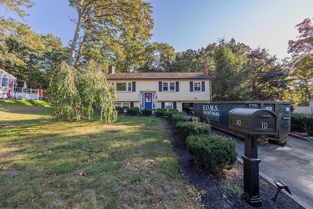 raised ranch with a front yard