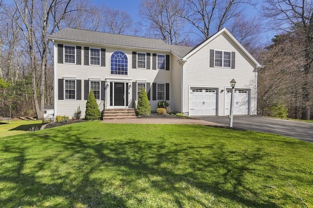 15 Whitewood Cir, Amesbury, MA 01913 - colonial home featuring an attached garage, aphalt driveway, and a front lawn