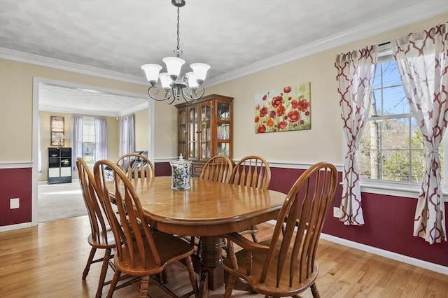 15 Whitewood Cir, Amesbury, MA 01913 - dining room featuring light wood-style flooring, baseboards, an inviting chandelier, and crown molding
