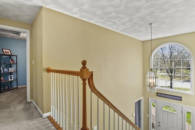 15 Whitewood Cir, Amesbury, MA 01913 - entrance foyer with a chandelier, carpet floors, a textured ceiling, and baseboards