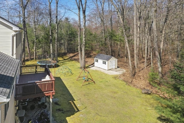 15 Whitewood Cir, Amesbury, MA 01913 - view of yard featuring a trampoline, an outbuilding, a storage shed, and a deck