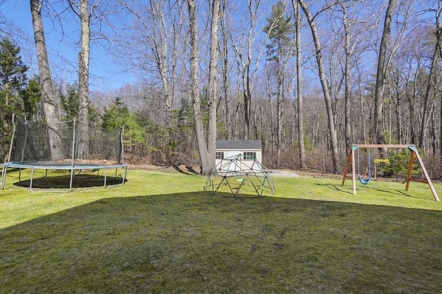 15 Whitewood Cir, Amesbury, MA 01913 - view of yard featuring a wooded view, a trampoline, and a playground
