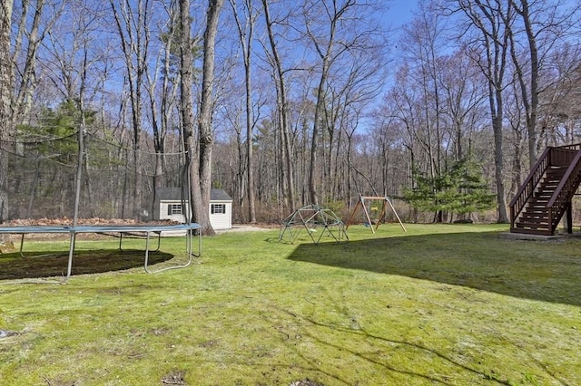 15 Whitewood Cir, Amesbury, MA 01913 - view of yard with a storage unit, a trampoline, an outbuilding, and stairway