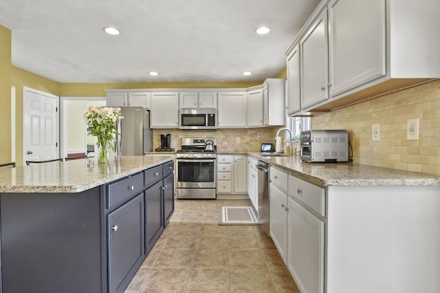 15 Whitewood Cir, Amesbury, MA 01913 - kitchen with light stone counters, tasteful backsplash, stainless steel appliances, and a sink
