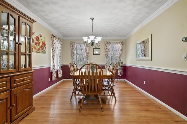15 Whitewood Cir, Amesbury, MA 01913 - dining space with baseboards, an inviting chandelier, light wood-style floors, and ornamental molding