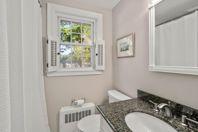 full bathroom featuring radiator, toilet, and vanity