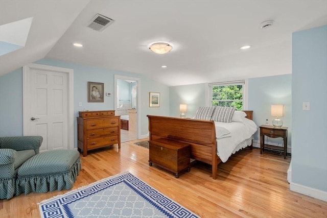 bedroom with light wood-style flooring, vaulted ceiling, recessed lighting, baseboards, and baseboard heating