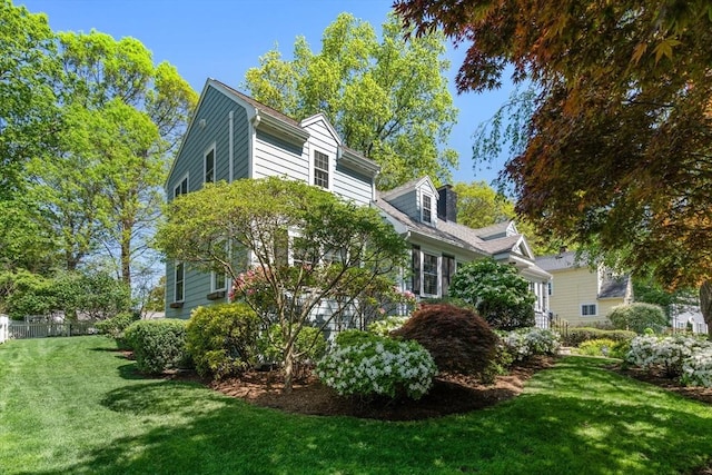 view of side of home featuring a lawn