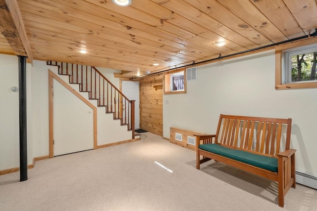 living area with wooden ceiling, carpet flooring, stairway, and baseboards