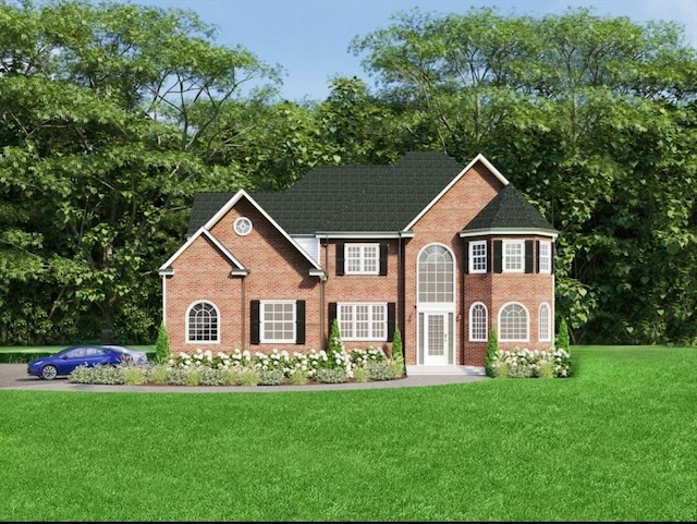 colonial inspired home with a front yard and brick siding