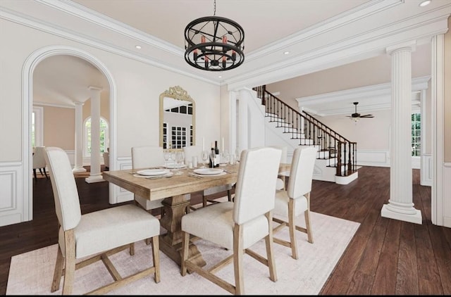 dining space featuring decorative columns, arched walkways, wood-type flooring, and a wainscoted wall