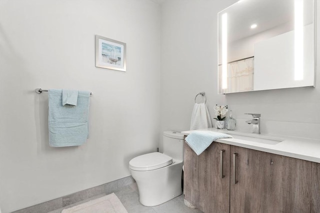 bathroom with vanity, curtained shower, tile patterned floors, and toilet