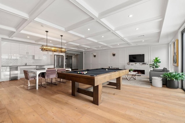 playroom featuring coffered ceiling, pool table, light hardwood / wood-style flooring, and beamed ceiling