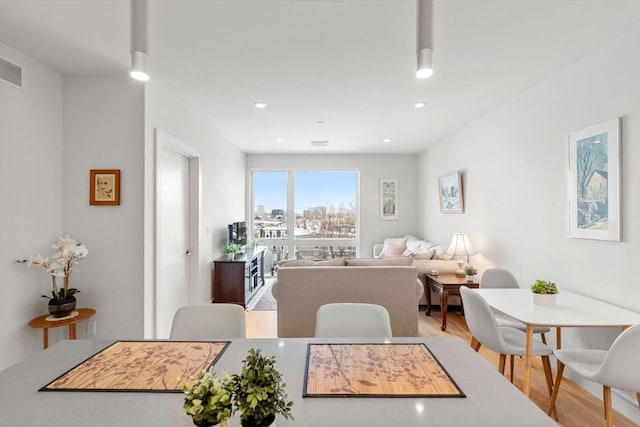 dining space with light wood-type flooring