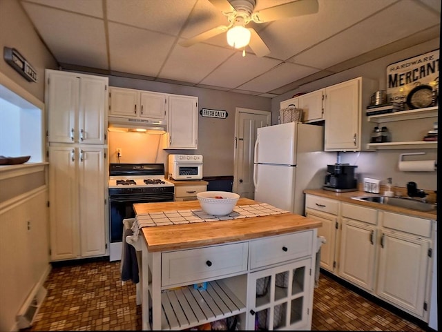 6 Cleveland Ave, Westfield, MA 01085 - kitchen featuring freestanding refrigerator, wooden counters, white cabinetry, under cabinet range hood, and range with gas cooktop