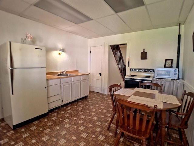 6 Cleveland Ave, Westfield, MA 01085 - kitchen featuring a paneled ceiling, a sink, white cabinets, butcher block counters, and white appliances