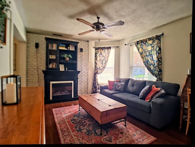 6 Cleveland Ave, Westfield, MA 01085 - living room with a textured ceiling, ceiling fan, a large fireplace, and wood finished floors