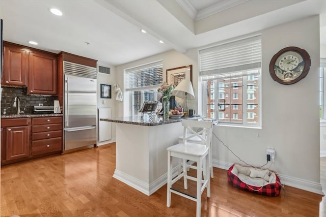 20 Chapel St Unit B811, Brookline, MA 02446 - kitchen with stainless steel built in refrigerator, plenty of natural light, ornamental molding, light wood-style floors, and baseboards