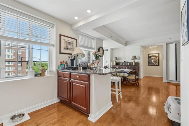 20 Chapel St Unit B811, Brookline, MA 02446 - kitchen with a breakfast bar, plenty of natural light, light wood-style floors, baseboards, and recessed lighting