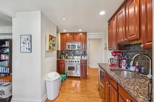20 Chapel St Unit B811, Brookline, MA 02446 - kitchen with stainless steel appliances, a sink, tasteful backsplash, dark stone counters, and light wood finished floors