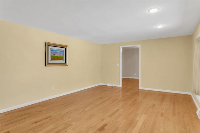 spare room featuring light wood-style flooring and baseboards