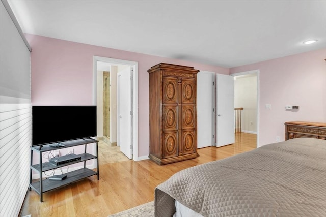 bedroom with baseboards and light wood-style floors