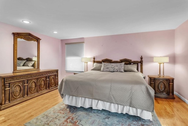 bedroom with baseboards, light wood-type flooring, and recessed lighting