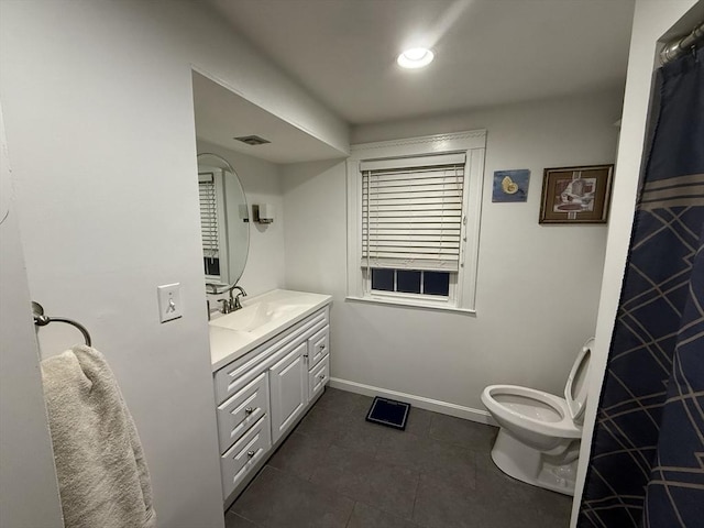 bathroom featuring visible vents, toilet, vanity, baseboards, and tile patterned floors