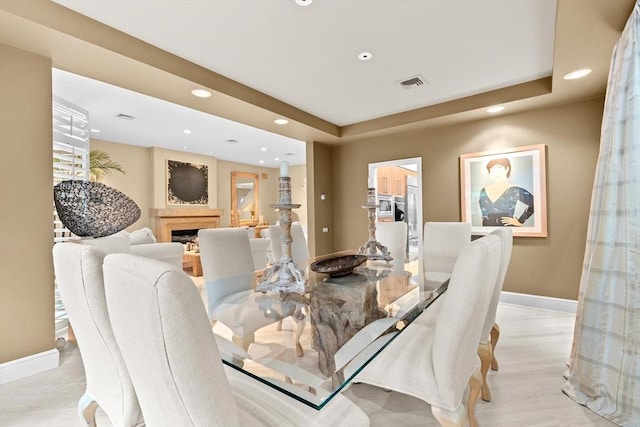 202 Allandale Rd Unit A, Boston, MA 02467 - dining room featuring baseboards, recessed lighting, a raised ceiling, a fireplace, and light wood-style flooring
