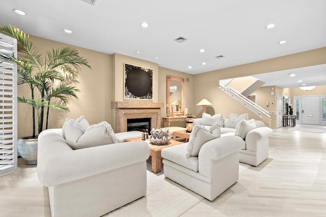 202 Allandale Rd Unit A, Boston, MA 02467 - living room with recessed lighting, a glass covered fireplace, light wood-style flooring, and stairs