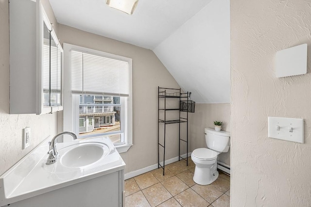150 Belmont St, Worcester, MA 01605 - bathroom with toilet, a baseboard heating unit, vanity, vaulted ceiling, and tile patterned floors