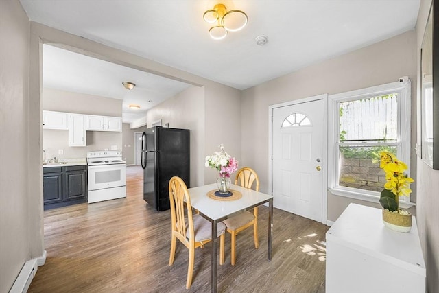 150 Belmont St, Worcester, MA 01605 - dining space with baseboard heating, wood finished floors, and baseboards