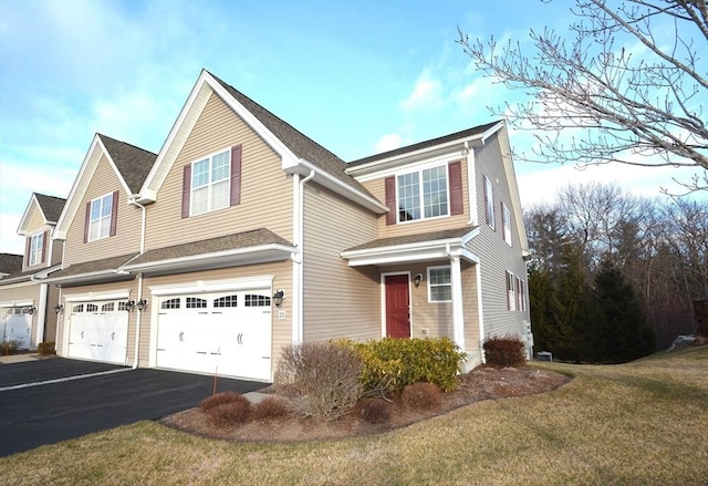 view of front of house with a front yard and a garage