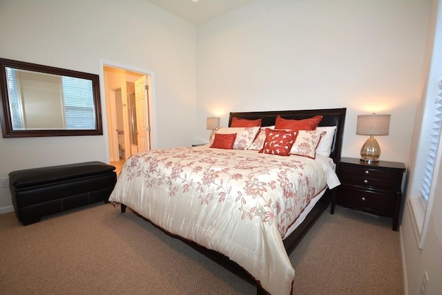 bedroom with light carpet and ensuite bathroom