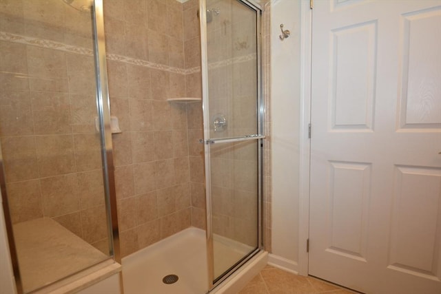 bathroom with tile patterned flooring and an enclosed shower