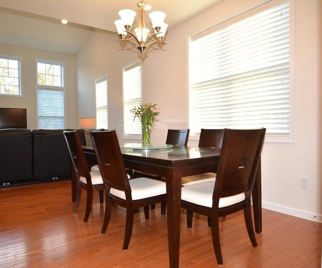 dining area featuring a notable chandelier and wood-type flooring