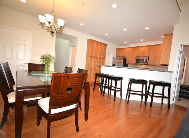 dining area featuring a chandelier and light wood-type flooring