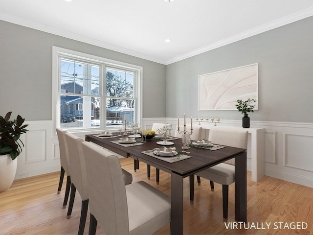 dining area featuring light hardwood / wood-style flooring and ornamental molding