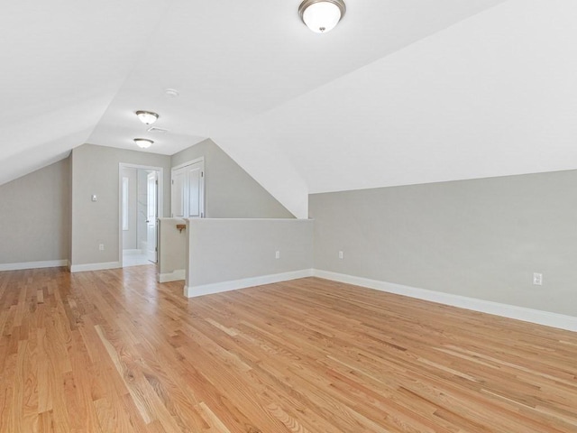 bonus room featuring light hardwood / wood-style floors and vaulted ceiling