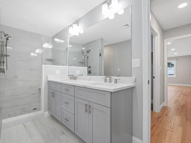 bathroom featuring a shower with door, vanity, and hardwood / wood-style flooring